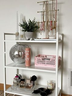 a white shelf with various items on it