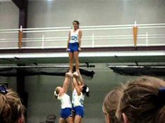 two women are performing acrobatic tricks on a stage