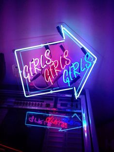 a neon sign that is on top of a radio set with the words ariis's girls above it