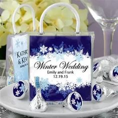 a blue and white winter wedding candy bag on a plate with silver foiled candies