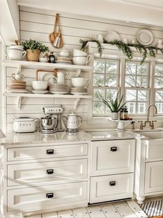 the kitchen is clean and ready to be used for cooking or baking, with dishes on shelves