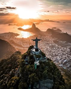 the statue is on top of a hill overlooking the city and ocean in rio, brazil