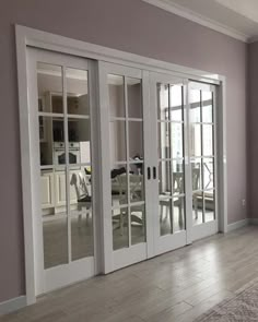 an empty room with french doors and windows