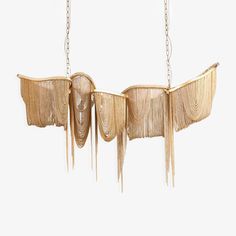 three hanging lights made out of wood with chains attached to the sides and fringes on each side