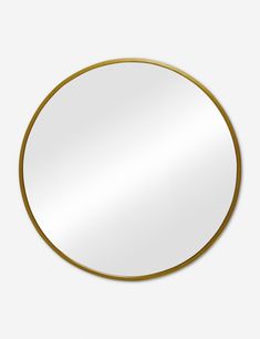 a round mirror with a gold rim