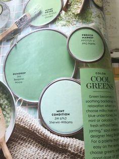 an open magazine with green paint and wooden spoons