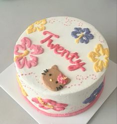 a birthday cake decorated with flowers and the words thank you on it's side