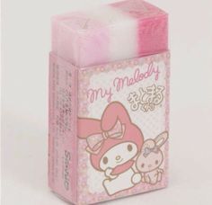 a pink and white box with hello kitty on the front, inside it is an eraser that says my melody