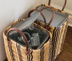 two wicker baskets with drinks in them sitting on the floor next to a wall