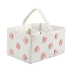 a white and pink polka dot fabric storage bin with two compartments on each side,