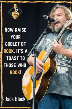 a man holding a guitar while standing in front of a microphone with a quote on it