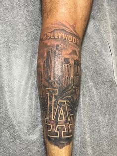 a man with a tattoo on his leg that has the word los angeles in it