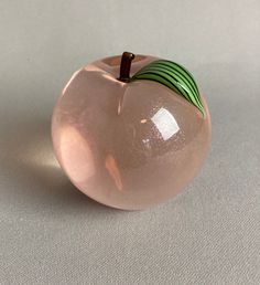 "This is a vintage Orient and Flume hand blown glass paperweight. It is a pink apple with iridescent glass and a green and back striped leaf ad brown stem.  It measures approx. 3\" wide x 3\" tall. It does not retain its' original label but it is signed on the bottom. with the company name and the name of the glassblower.   It is in pristine condition." Glass Apple, Glass Fruit, Pink Apple, Glass Paperweights, San Luis Obispo, Paperweights, Red Brown, Hand Blown Glass, Blown Glass