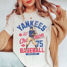 Step up to the plate in style with the "Vintage Baseball Team" Tee, showcasing iconic designs of your favorite MLB teams from the golden era of baseball. Crafted from premium fabric, this tee ensures both comfort and durability, making it perfect for honoring the rich history of America's favorite pastime. The vintage-inspired designs capture the nostalgia and heritage of classic MLB teams, bringing the spirit of the ballpark to your wardrobe. Whether you're cheering from the stands or reminiscing about baseball legends of yesteryear, this tee is the perfect choice for any fan. Its relaxed fit guarantees all-day comfort, while the authentic vintage designs add a touch of retro charm to your ensemble. From game days to casual outings, this tee is a versatile addition to your wardrobe, allow Fan Apparel Baseball Jersey With Crew Neck, Collegiate Baseball Jersey With Graphic Print For Fans, Throwback Tops For Baseball Game Day, Fan Apparel Baseball Jersey With Graphic Print, Throwback Letter Print T-shirt For College, Throwback Baseball Fan Tops, Throwback Cotton Tops For Baseball Season, Throwback Baseball Season Fan T-shirt, Throwback Baseball Fan Merchandise T-shirt