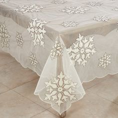 a white table cloth with snowflakes on it