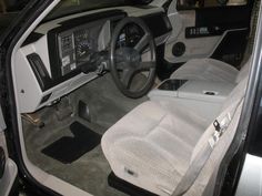 the interior of a car with white cloths on the floor and steering wheel cover