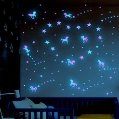 a child's room with stars and unicorns on the wall