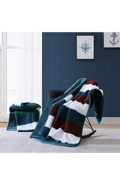 a chair and blanket in a room with blue walls