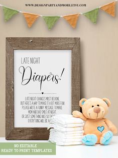 a teddy bear sitting next to a pile of diapers in front of a sign