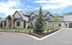 a large house with lots of windows and landscaping