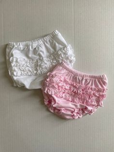 Buy 2 and save. Made of 100% pima cotton. Super soft and perfect for cover up those diapers. Comes with one of each color-solid white and solid pink. White Cotton Bloomers With Ruffles, White Cotton Ruffled Bloomers, White Cotton Bloomers With Elastic Waistband, Cute White Bloomers With Elastic Waistband, White Cotton Diaper Cover With Elastic Waistband, White Bloomers For Spring Playwear, Spring White Bloomers For Playwear, White Cotton Bloomers For Playwear, Fitted White Cotton Diaper Cover