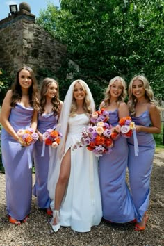 the bride and her bridesmaids pose for a photo