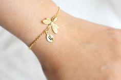 Super cute Honey bee bracelet.Great jewelry for any occasion.▶▶ You can make this bracelet personal, choosing quantity of the letter leaf from option.Please leave a note for the desired letters in the Personalization section.▶ Material - gold or Rhodium plated over brass▶ Chain Length - 6.5 ~ 7.5 inches adjustable (or Custom length available)▶  Measurement - Bee H. 14mm x W. 18mm, Leaf H. 11mm x W. 6mm▶ Letter height - 3mm▶ All the jewelry comes in a gift box individually.▶ The matching necklace Charming Bracelet Jewelry Gift, Dainty Handmade Bracelets For Bridesmaids, Dainty Bangle Charm Bracelet For Gift, Dainty Bangle Charm Bracelet As Gift, Delicate Hypoallergenic Charm Bracelet Gift, Handmade Dainty Bracelets For Best Friend, Handmade Dainty Bracelet For Best Friend, Dainty Handmade Name Bracelet Gift, Bee Hexagon