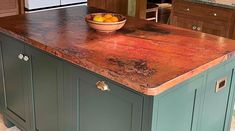 a bowl of fruit on top of a kitchen island