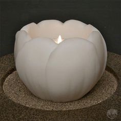 a white candle sitting on top of a table