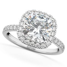 a diamond engagement ring with an oval center surrounded by round diamonds