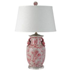 a red and white vase with a lamp on it's side, against a white background