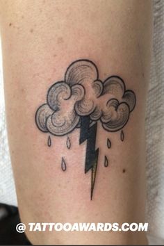 a black and white photo of a cloud with a lightning tattoo on the leg that has rain coming out of it