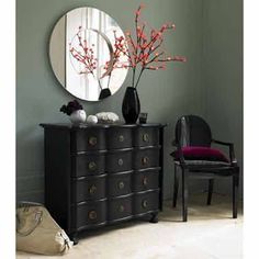 a black dresser and mirror in a room