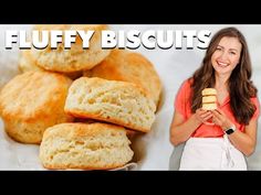 a woman standing next to a pile of biscuits and the words fluffy biscuits on it