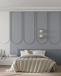 a large bed sitting in a bedroom next to a wall mounted light above it's headboard