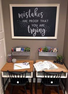 two desks with chairs and a chalkboard on the wall above them that says, make