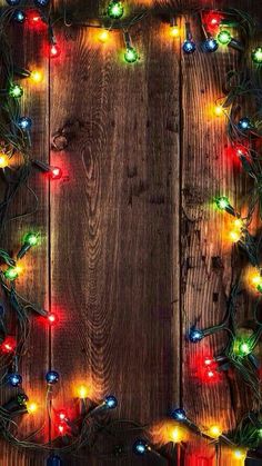 an image of christmas lights on wood background