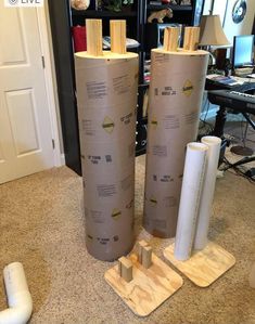 two large rolls of cardboard sitting on top of a floor