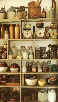 a shelf filled with lots of different types of kitchen utensils and other items