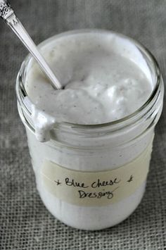 a glass jar filled with white cream and a spoon