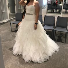 a woman in a wedding dress is taking a selfie