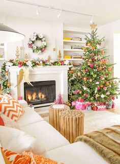 a living room filled with furniture and a fire place covered in christmas tree decorations next to a fireplace