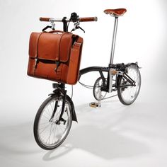 a bicycle with a brown leather bag on the back