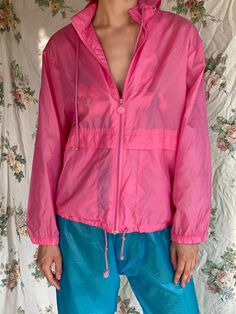 "Gender neutral hoodie swishy windbreaker. Maybe a little water proof? For the pants: https://www.etsy.com/listing/1234578829/1980s-swishy-pants-semi-sheer-blue?click_key=d3c7f4732e47c36718ea664fb43eae5b37f7b3c6%3A1234578829&click_sum=2efbb960&ref=shop_home_active_4 Bust: 44\" Circa: 1980's Condition: Good vintage condition. Normal wear. Follow us on Instagram for the latest----> http://instagram.com/closetcasevintage @closetcasevintage Please read our store policies." Pink Nylon Hooded Jacket With Long Sleeves, Pink Long Sleeve Nylon Hooded Jacket, Pink Hooded Jacket With Pockets For Streetwear, Trendy Hooded Windbreaker For Outdoor, Trendy Spring Raincoat For Rainy Weather, Spring Nylon Hooded Jacket With Pockets, Spring Nylon Hooded Jacket With Adjustable Hood, Casual Windbreaker With Drawstring Hood For Rainy Season, Spring Nylon Windbreaker For Rainy Weather