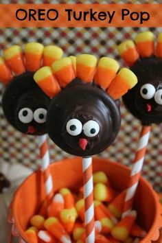 two chocolate turkey pops with candy sticks in the middle and one has eyes on it