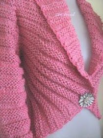 a close up of a pink sweater on a mannequin headdress,