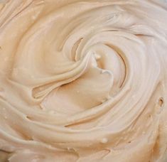 a bowl filled with cream sitting on top of a table