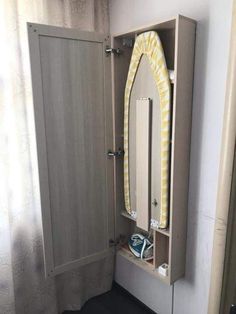 a bathroom with a mirror, sink and cabinet in the corner on the floor next to a window