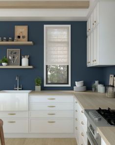 a kitchen with blue walls and white cabinets is pictured in this image, there are shelves on the wall above the sink