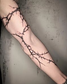 a man's arm with barbed wire on it